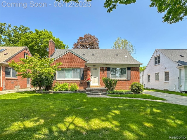 2195 Pembroke Rd, Birmingham, MI 48009 - bungalow with brick siding, a front yard, and a chimney