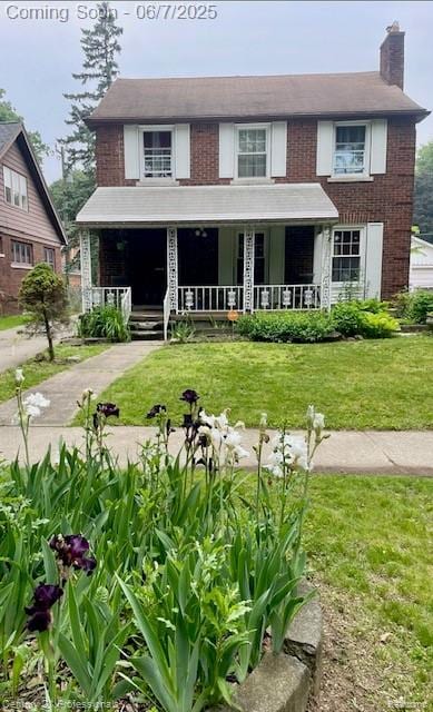 14603 Greenview Rd, Detroit, MI 48223 - view of front of home with a chimney, a porch, a front yard, and brick siding
