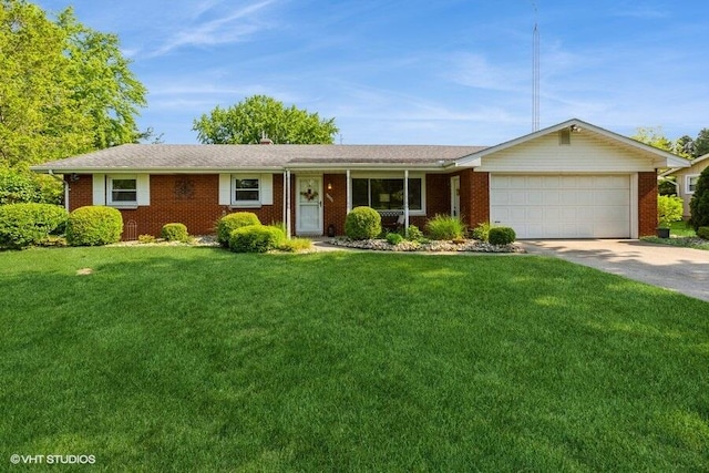 1787 Trafalgar Dr, Saint Joseph, MI 49085 - ranch-style house with an attached garage, driveway, brick siding, and a front lawn