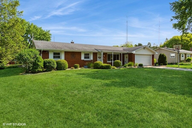 1787 Trafalgar Dr, Saint Joseph, MI 49085 - ranch-style house with an attached garage, concrete driveway, a front yard, and brick siding