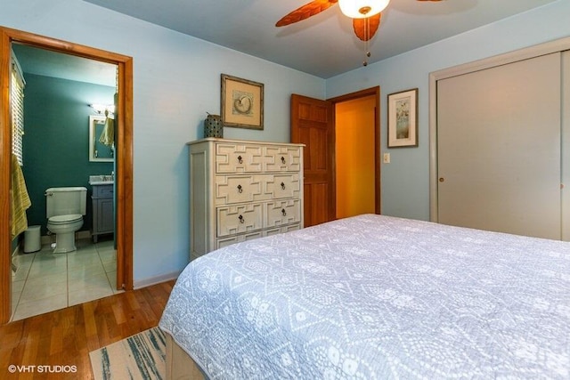 1787 Trafalgar Dr, Saint Joseph, MI 49085 - bedroom featuring wood finished floors, connected bathroom, a ceiling fan, and a closet