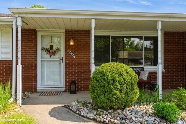 1787 Trafalgar Dr, Saint Joseph, MI 49085 - view of exterior entry with brick siding and covered porch