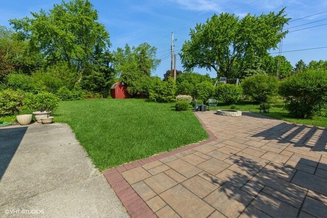 1787 Trafalgar Dr, Saint Joseph, MI 49085 - view of green lawn featuring a fire pit and a patio area