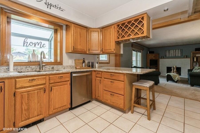 1787 Trafalgar Dr, Saint Joseph, MI 49085 - kitchen with dishwasher, a sink, a peninsula, and light tile patterned flooring