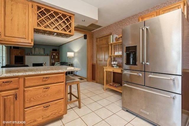 1787 Trafalgar Dr, Saint Joseph, MI 49085 - kitchen with high end refrigerator, light countertops, light tile patterned floors, and wallpapered walls