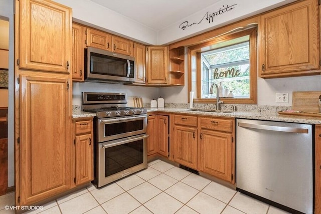 1787 Trafalgar Dr, Saint Joseph, MI 49085 - kitchen featuring stainless steel appliances, a sink, light stone countertops, light tile patterned floors, and open shelves