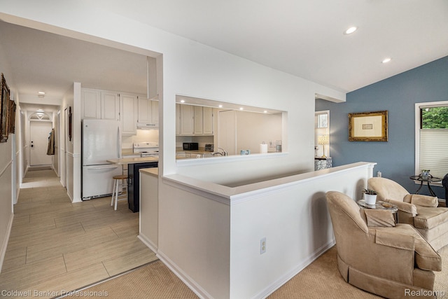 1704 Clark Lake Rd, Brighton, MI 48114 - kitchen with white appliances, lofted ceiling, recessed lighting, light countertops, and white cabinets