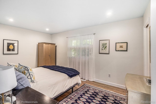 1704 Clark Lake Rd, Brighton, MI 48114 - bedroom featuring wood finished floors, baseboards, and recessed lighting