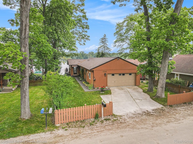 1704 Clark Lake Rd, Brighton, MI 48114 - view of front facade featuring concrete driveway, a garage, and a shingled roof