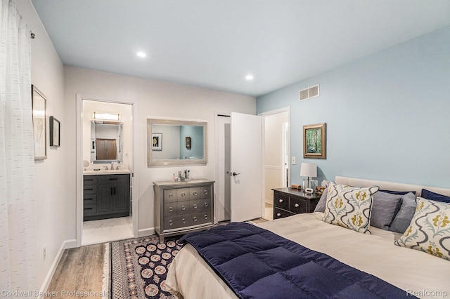 1704 Clark Lake Rd, Brighton, MI 48114 - bedroom with wood finished floors, recessed lighting, a sink, ensuite bath, and baseboards
