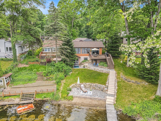 1704 Clark Lake Rd, Brighton, MI 48114 - rear view of house with stairs, a deck with water view, a patio, and a lawn