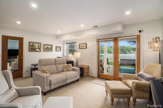 1704 Clark Lake Rd, Brighton, MI 48114 - living area with light colored carpet, a water view, recessed lighting, and baseboards