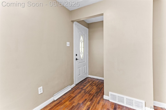 3428 Lennon Rd, Flint, MI 48507 - entrance foyer featuring baseboards, dark wood finished floors, and a baseboard heating unit