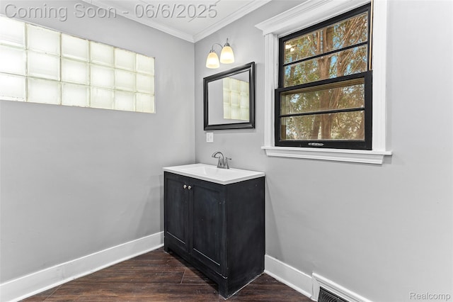 3428 Lennon Rd, Flint, MI 48507 - bathroom with baseboards, crown molding, vanity, and wood finished floors
