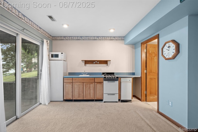 6300 Bullard Rd, Fenton, MI 48430 - kitchen with white appliances, light carpet, a sink, and brown cabinetry