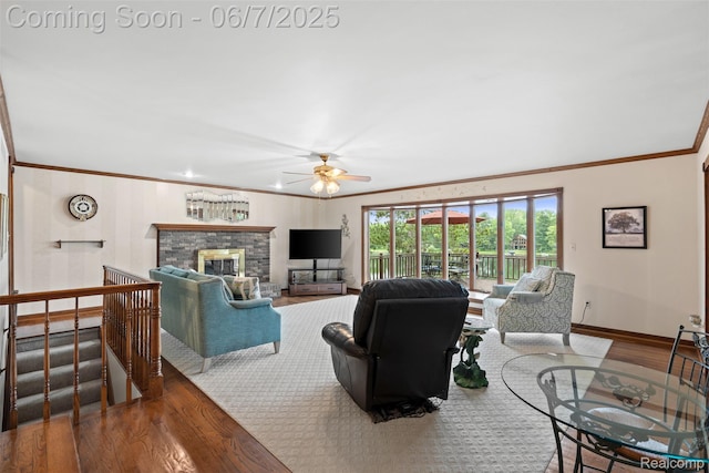 6300 Bullard Rd, Fenton, MI 48430 - living area with crown molding, wood finished floors, ceiling fan, baseboards, and a glass covered fireplace