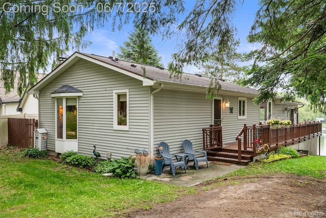 6300 Bullard Rd, Fenton, MI 48430 - rear view of property featuring a deck, roof with shingles, and a patio