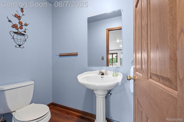 6300 Bullard Rd, Fenton, MI 48430 - half bath with wood finished floors, toilet, and baseboards