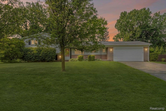 2985 Lacota Rd, Farmington, MI 48328 - view of front of property featuring driveway, an attached garage, a yard, and brick siding