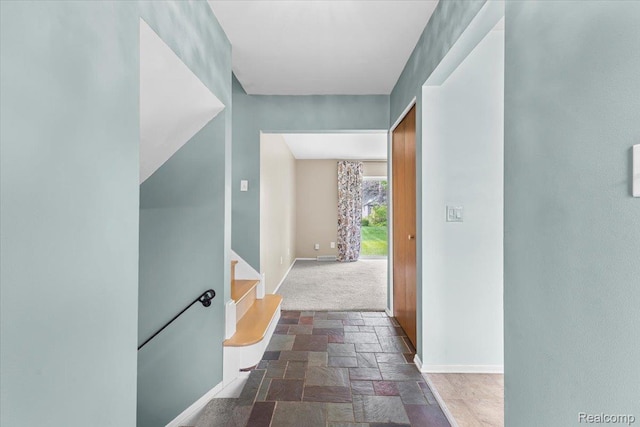 2985 Lacota Rd, Farmington, MI 48328 - hallway featuring stone tile floors, baseboards, and stairs