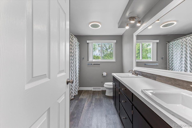 2985 Lacota Rd, Farmington, MI 48328 - full bath with double vanity, toilet, wood finished floors, baseboards, and a shower with curtain