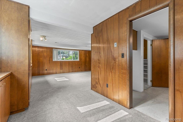 2985 Lacota Rd, Farmington, MI 48328 - carpeted empty room featuring wood walls and stairs