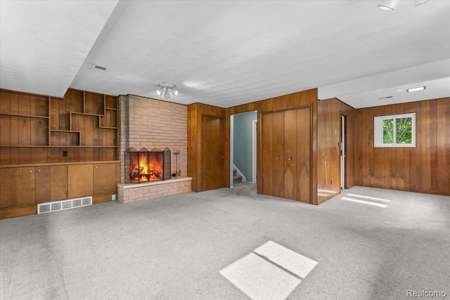 2985 Lacota Rd, Farmington, MI 48328 - unfurnished living room featuring wooden walls, a brick fireplace, stairway, and carpet flooring