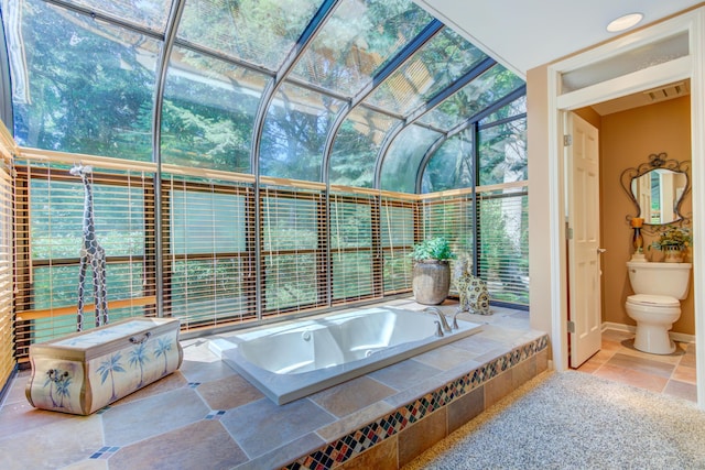4298 Braeburn Ct, Norton Shores, MI 49441 - full bathroom with a garden tub, toilet, and baseboards