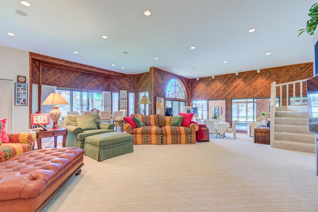4298 Braeburn Ct, Norton Shores, MI 49441 - carpeted living area with wooden walls, recessed lighting, and stairs