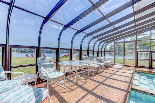 4298 Braeburn Ct, Norton Shores, MI 49441 - sunroom featuring a water view, lofted ceiling, and a pool