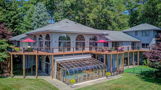 4298 Braeburn Ct, Norton Shores, MI 49441 - rear view of property featuring a wooden deck, a patio area, and a shingled roof
