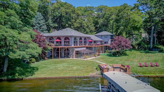 4298 Braeburn Ct, Norton Shores, MI 49441 - dock area featuring a deck with water view and a lawn