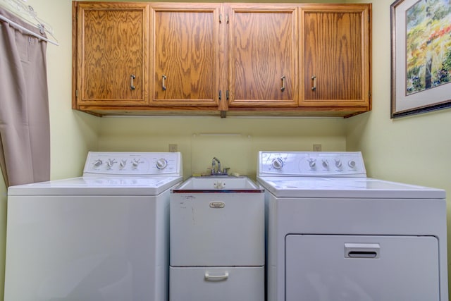 4298 Braeburn Ct, Norton Shores, MI 49441 - laundry room featuring cabinet space and washer and clothes dryer