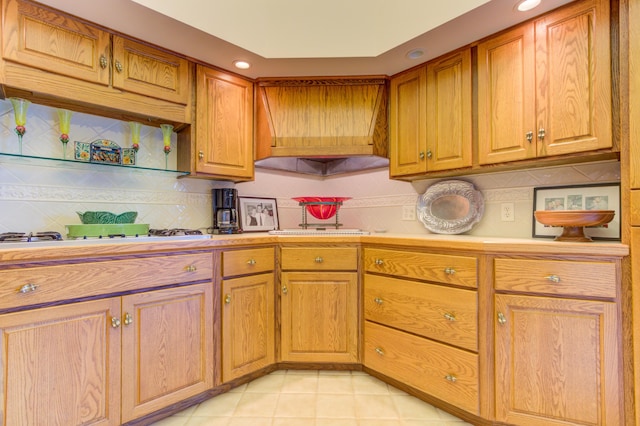 4298 Braeburn Ct, Norton Shores, MI 49441 - kitchen with light countertops, gas cooktop, tasteful backsplash, light tile patterned floors, and recessed lighting
