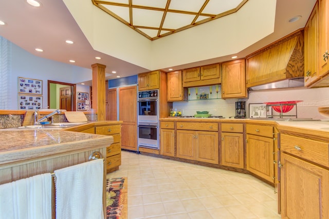 4298 Braeburn Ct, Norton Shores, MI 49441 - kitchen with double oven, a sink, ornate columns, tasteful backsplash, and recessed lighting