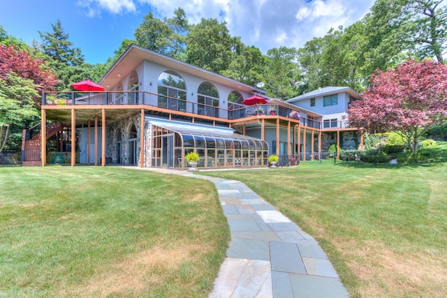 4298 Braeburn Ct, Norton Shores, MI 49441 - back of property with a deck, stairway, and a yard
