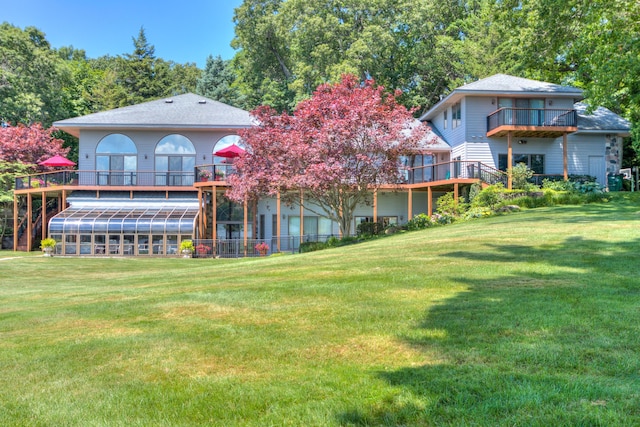 4298 Braeburn Ct, Norton Shores, MI 49441 - back of house featuring a balcony and a lawn