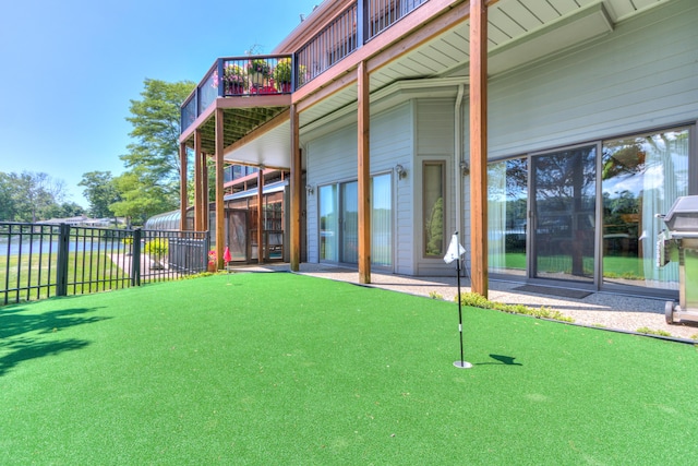 4298 Braeburn Ct, Norton Shores, MI 49441 - back of property with a putting area and a deck