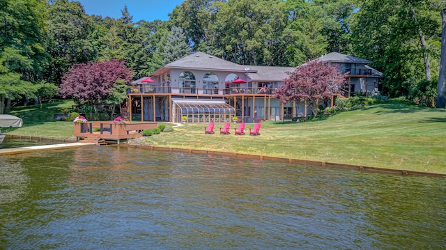 4298 Braeburn Ct, Norton Shores, MI 49441 - rear view of property featuring a deck with water view and a yard