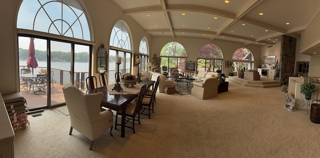 4298 Braeburn Ct, Norton Shores, MI 49441 - dining area featuring a water view, light colored carpet, plenty of natural light, recessed lighting, and high vaulted ceiling