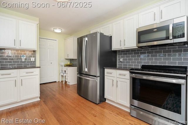 468 Orchard Ridge Dr, Lake Orion, MI 48362 - kitchen with stainless steel appliances, light wood finished floors, decorative backsplash, and white cabinets