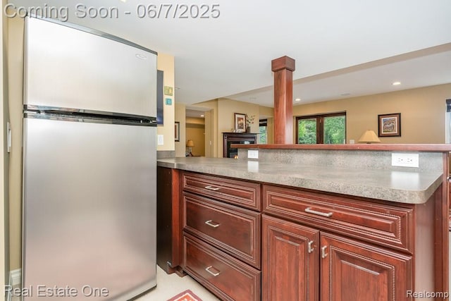 468 Orchard Ridge Dr, Lake Orion, MI 48362 - kitchen with freestanding refrigerator, a peninsula, light countertops, and decorative columns