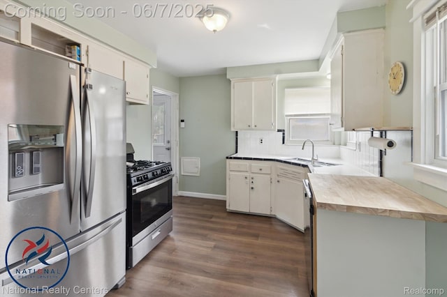 9036 Nathaline, Redford, MI 48239 - kitchen featuring stainless steel appliances, dark wood-style flooring, a sink, tasteful backsplash, and white cabinets