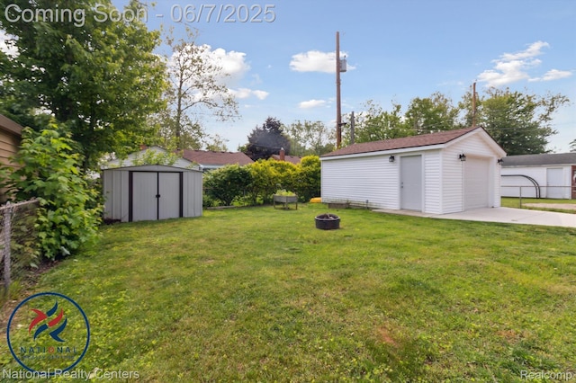 9036 Nathaline, Redford, MI 48239 - view of yard with an outdoor structure, a detached garage, an outdoor fire pit, and driveway