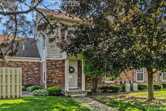 35638 Stillmeadow Ln, Clinton Township, MI 48035 - view of property hidden behind natural elements with brick siding and a shingled roof