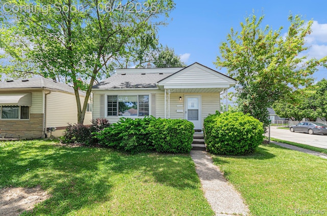 24309 Tuscany Ave, Eastpointe, MI 48021 - bungalow-style home featuring a front yard and covered porch
