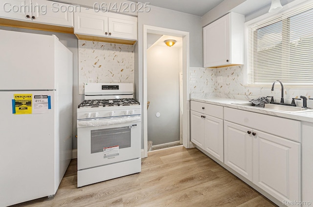 24309 Tuscany Ave, Eastpointe, MI 48021 - kitchen with white appliances, a sink, white cabinets, decorative backsplash, and light wood-style flooring
