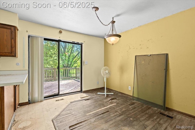 13041 Big Lake Rd, Davisburg, MI 48350 - unfurnished dining area featuring baseboards and a textured ceiling