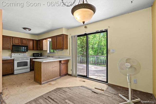 13041 Big Lake Rd, Davisburg, MI 48350 - kitchen featuring white electric range oven, black microwave, a peninsula, a sink, and light countertops