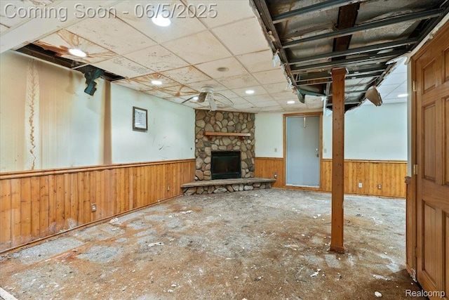 13041 Big Lake Rd, Davisburg, MI 48350 - unfurnished living room featuring wainscoting, a fireplace, and wood walls